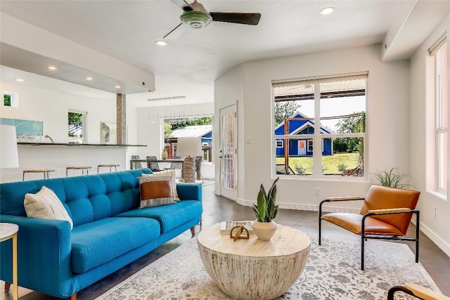 living room featuring wood-type flooring and ceiling fan