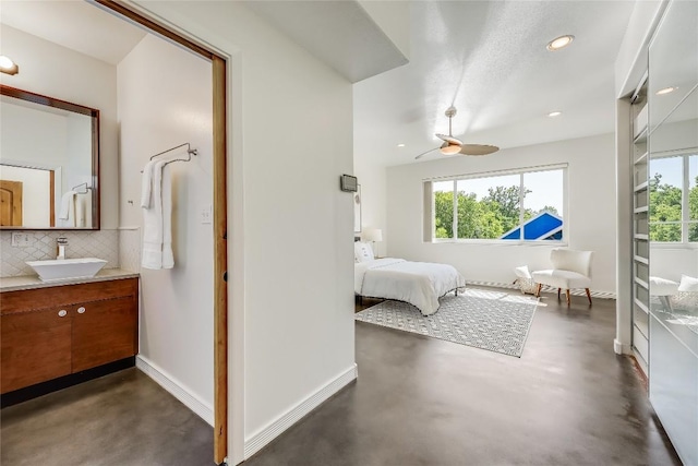 bedroom with multiple windows and sink