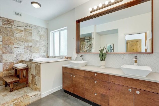 bathroom featuring vanity, backsplash, and concrete floors