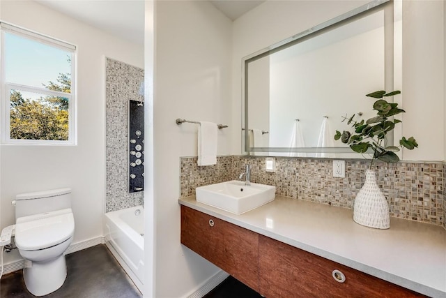 bathroom with vanity, a washtub, backsplash, and toilet