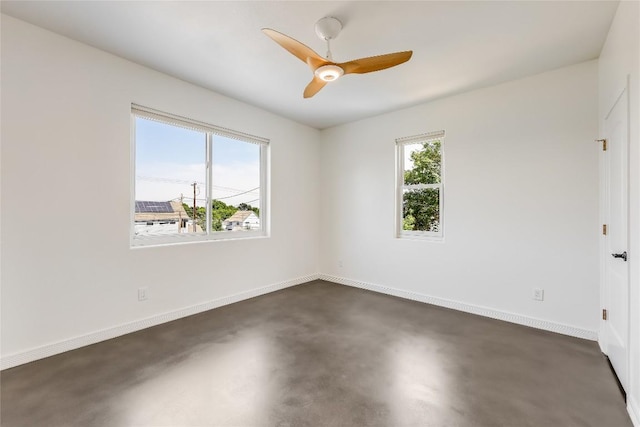 empty room featuring ceiling fan and a healthy amount of sunlight