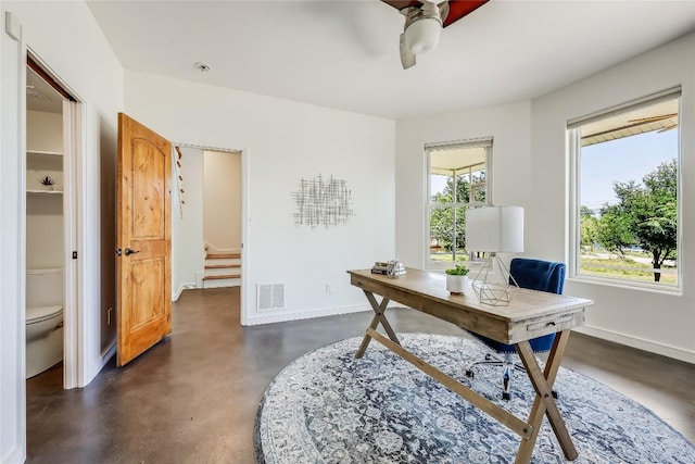 office with a wealth of natural light and ceiling fan