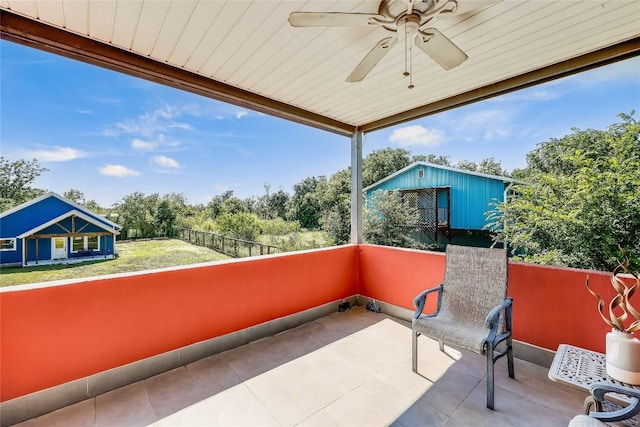 balcony with ceiling fan and a patio