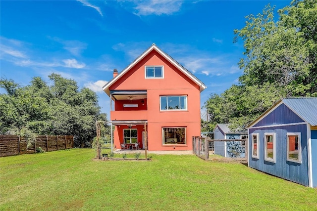 rear view of house with a yard