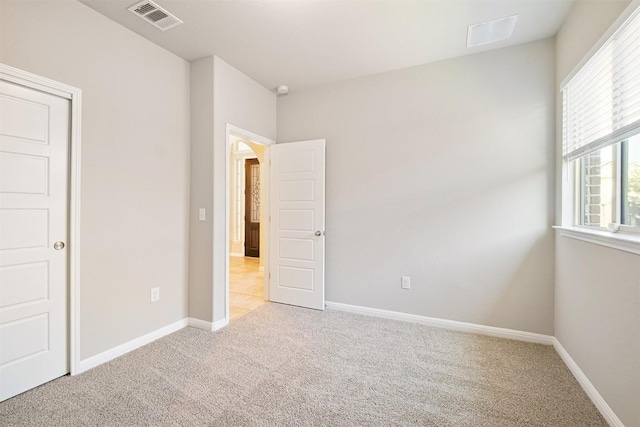 unfurnished bedroom with light colored carpet