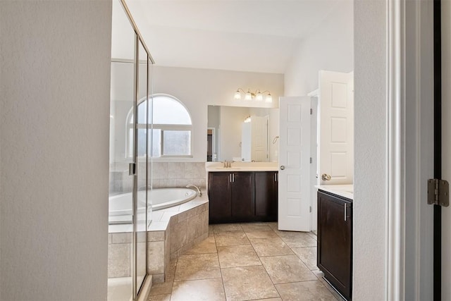 bathroom featuring vanity and separate shower and tub