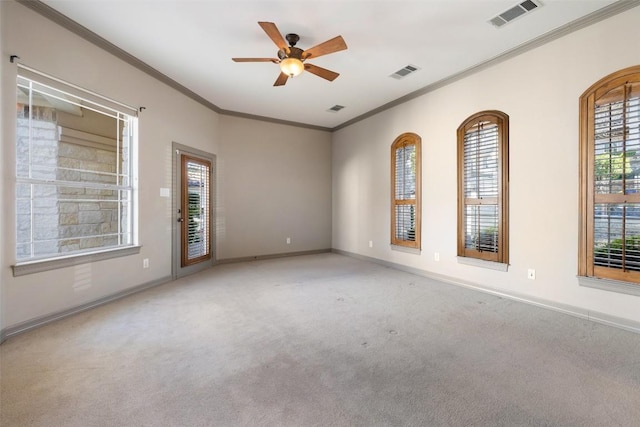 carpeted spare room featuring ornamental molding and ceiling fan