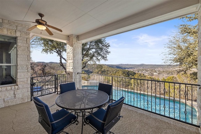 balcony featuring ceiling fan and a mountain view