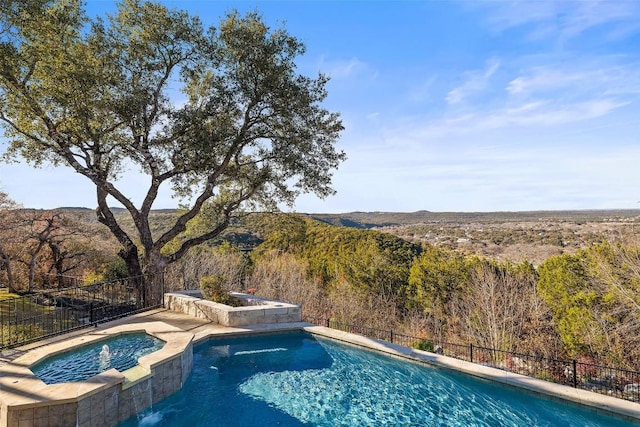 view of pool with an in ground hot tub