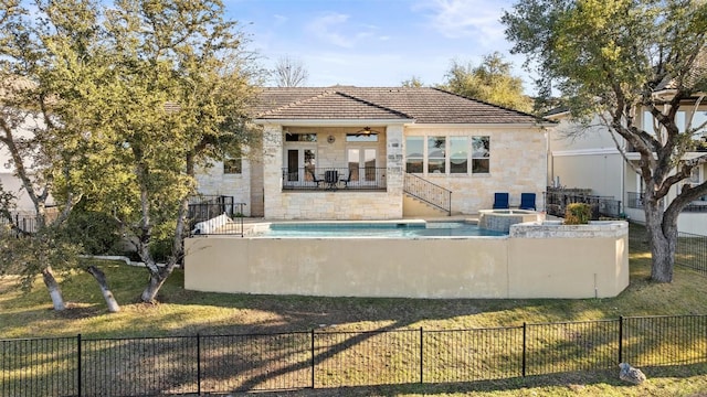 back of house featuring a patio, a balcony, ceiling fan, a pool with hot tub, and french doors