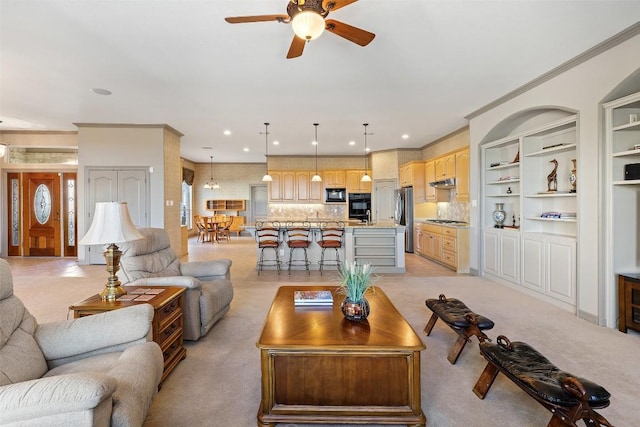 carpeted living room featuring ceiling fan and ornamental molding