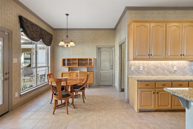 dining space featuring ornamental molding, a chandelier, and light tile patterned floors