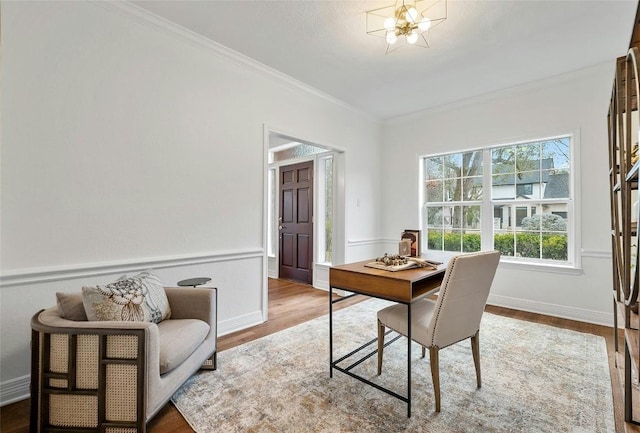 dining area with ornamental molding, an inviting chandelier, and light hardwood / wood-style floors