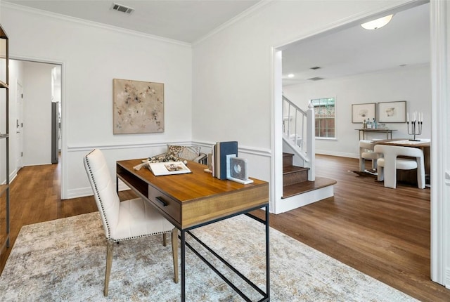 dining area with hardwood / wood-style floors and crown molding