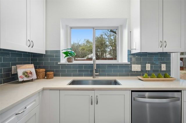 kitchen with white cabinetry, dishwasher, sink, and decorative backsplash