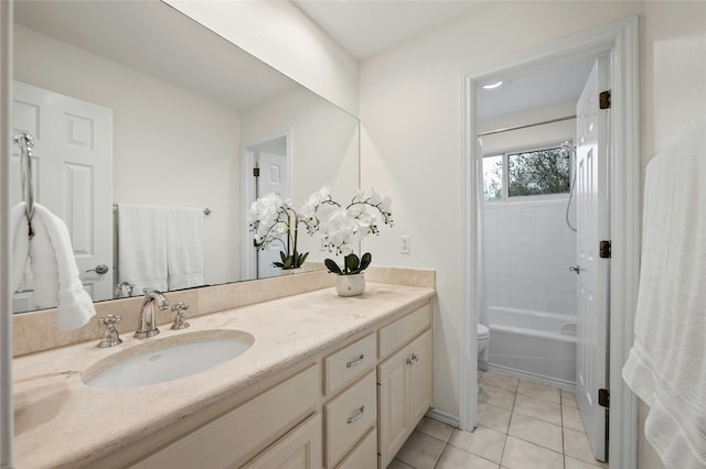 full bathroom with vanity, toilet, tiled shower / bath combo, and tile patterned flooring