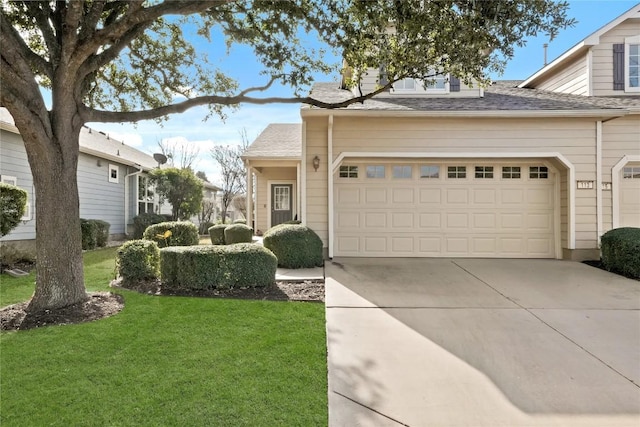 view of front of home with a garage and a front yard