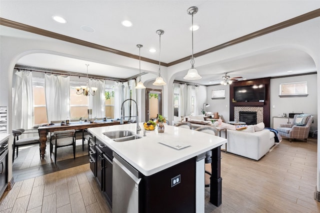 12332 Terraza Cir, Austin, TX 78726 - kitchen featuring a sink, stainless steel dishwasher, crown molding, arched walkways, and ceiling fan