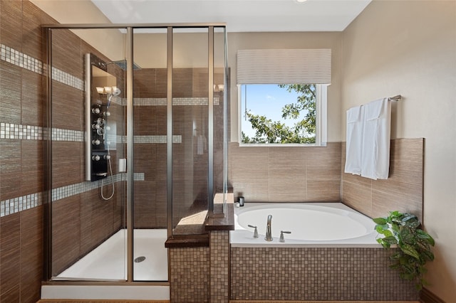 bathroom featuring separate shower and tub