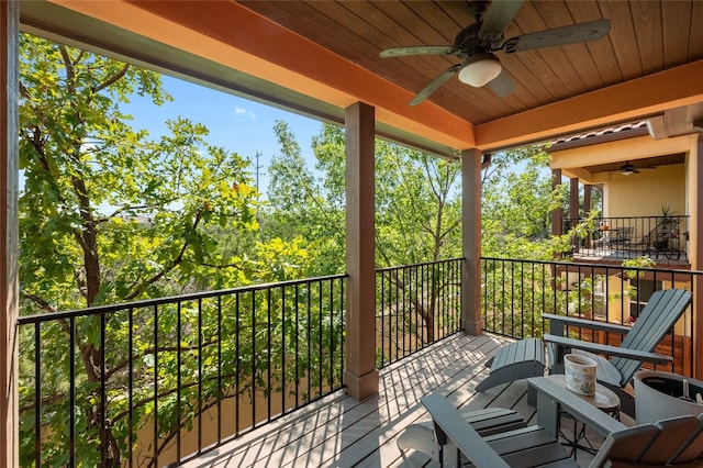 wooden deck featuring ceiling fan