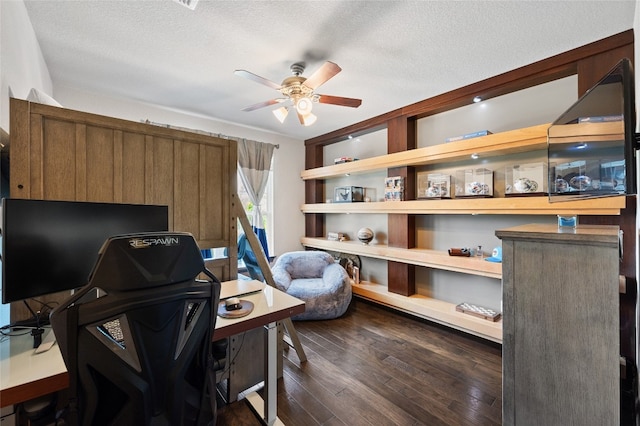 office featuring a textured ceiling, ceiling fan, and dark wood-style flooring