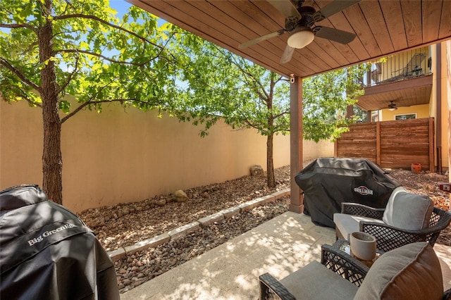 view of patio / terrace featuring ceiling fan, area for grilling, a fenced backyard, and a balcony