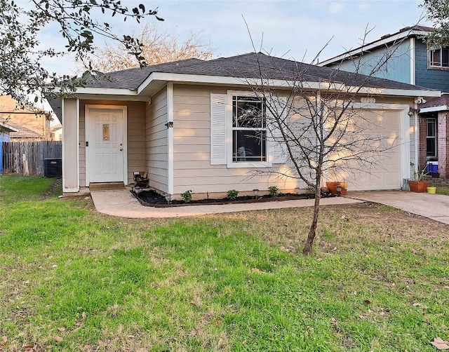 single story home with central AC unit, concrete driveway, an attached garage, fence, and a front yard