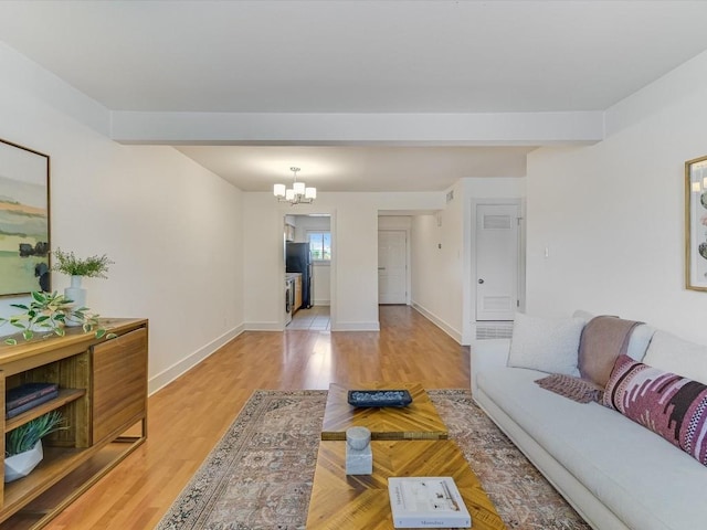 living room featuring a notable chandelier and light hardwood / wood-style flooring