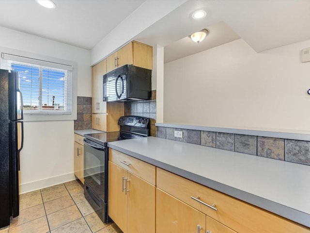 kitchen featuring light brown cabinetry, light tile patterned floors, decorative backsplash, and black appliances