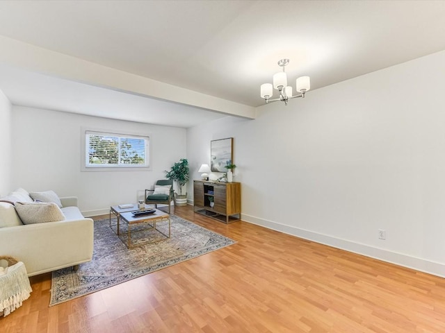 living room with beamed ceiling, a chandelier, and hardwood / wood-style floors