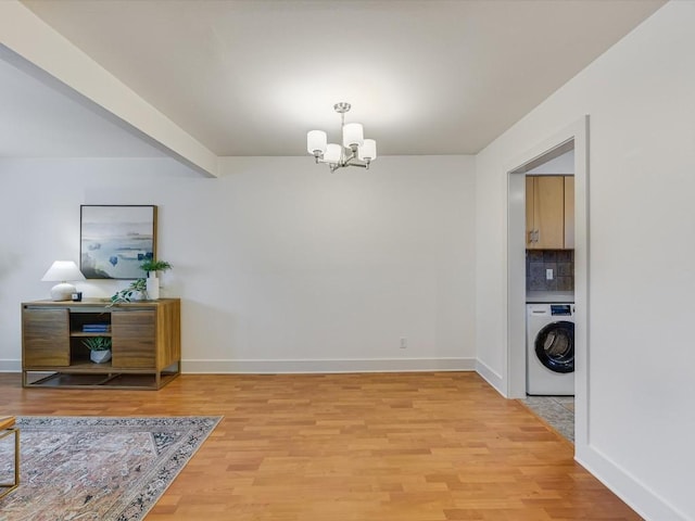 dining room with beam ceiling, washer / clothes dryer, a notable chandelier, and light hardwood / wood-style flooring