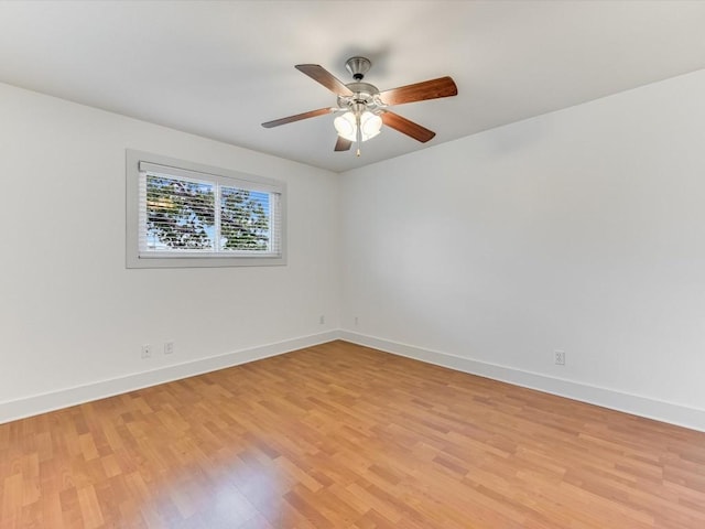 empty room with ceiling fan and light hardwood / wood-style flooring