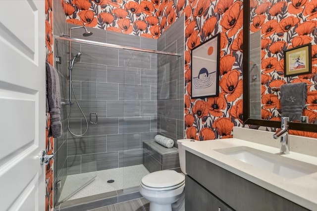 bathroom with vanity, walk in shower, and toilet