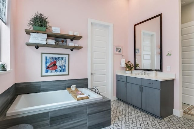 bathroom featuring vanity and tiled bath