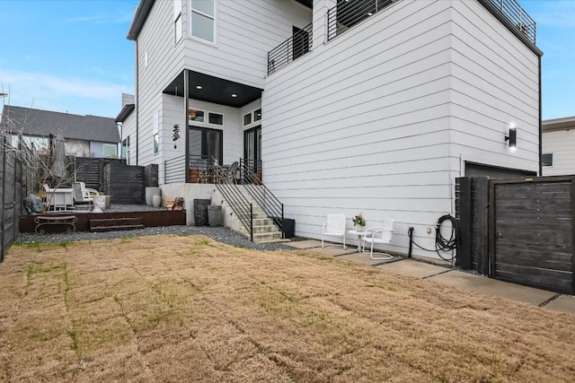 rear view of property featuring a lawn