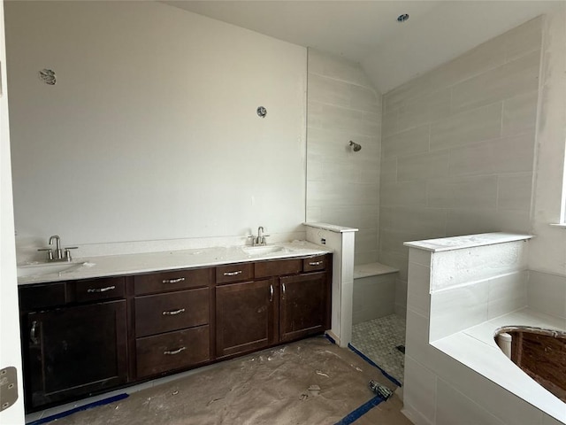 bathroom with vanity, separate shower and tub, and lofted ceiling