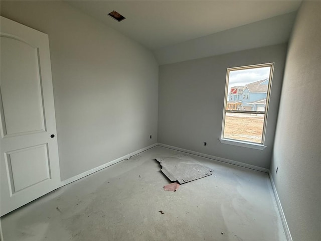 unfurnished room with lofted ceiling