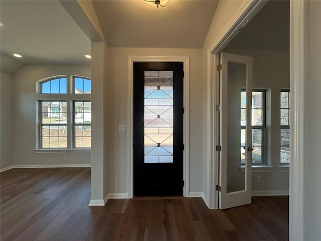 foyer featuring vaulted ceiling, recessed lighting, dark wood finished floors, and baseboards