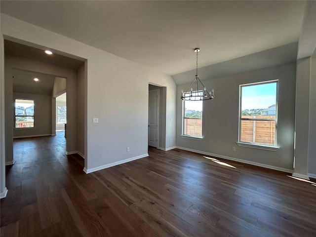 unfurnished dining area with a chandelier, vaulted ceiling, dark wood-style floors, and baseboards