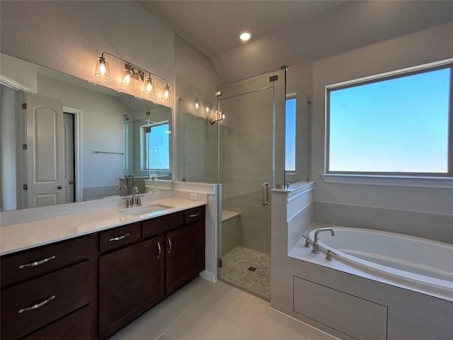 bathroom with a stall shower, a garden tub, vaulted ceiling, vanity, and recessed lighting