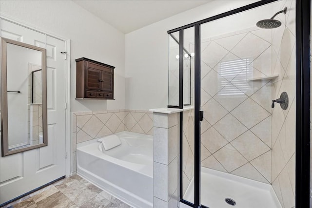 bathroom featuring separate shower and tub