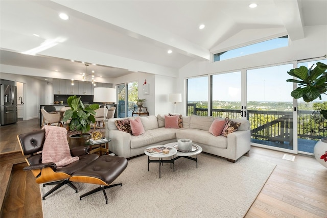 living area with visible vents, vaulted ceiling, wood finished floors, and recessed lighting