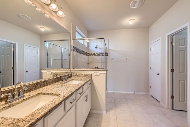 bathroom featuring vanity, tile patterned flooring, and a shower with shower door