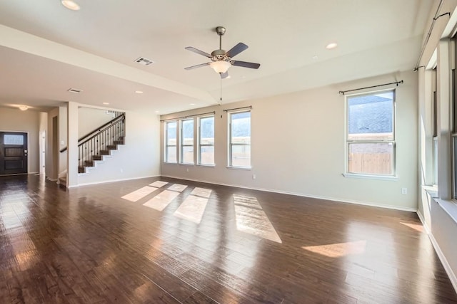 unfurnished living room featuring recessed lighting, dark wood finished floors, baseboards, and stairs