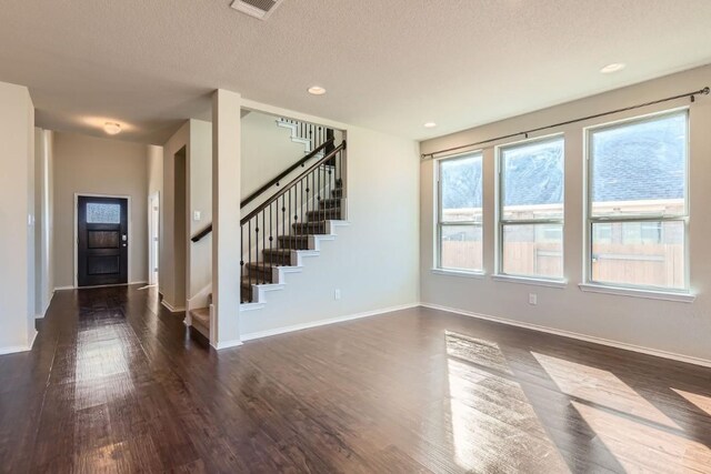 interior space with dark hardwood / wood-style floors and a textured ceiling