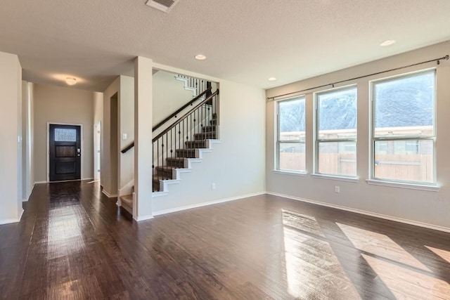 3264 Pablo Cir, Round Rock, TX 78665 - unfurnished living room featuring stairs, dark wood-style flooring, a textured ceiling, and recessed lighting
