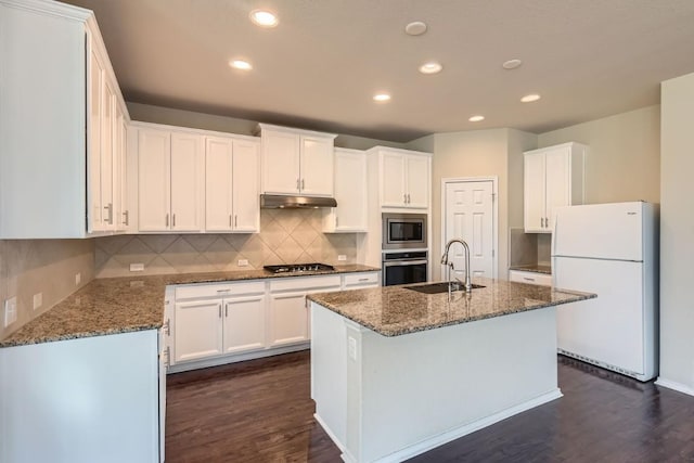 kitchen featuring sink, dark hardwood / wood-style flooring, stainless steel appliances, a kitchen island with sink, and white cabinets