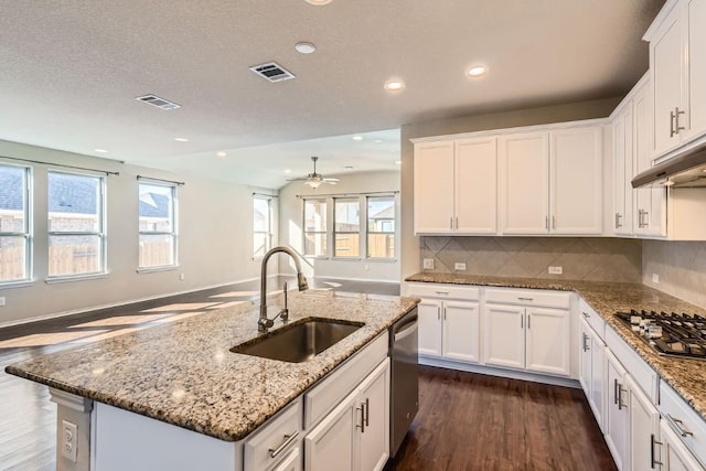 kitchen with white cabinetry, stainless steel appliances, a kitchen island with sink, and sink