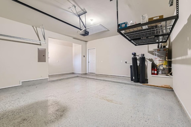 garage featuring heating unit, a garage door opener, electric panel, and water heater