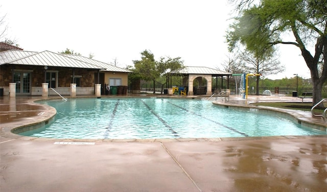 view of swimming pool featuring a gazebo, pool water feature, and a patio area